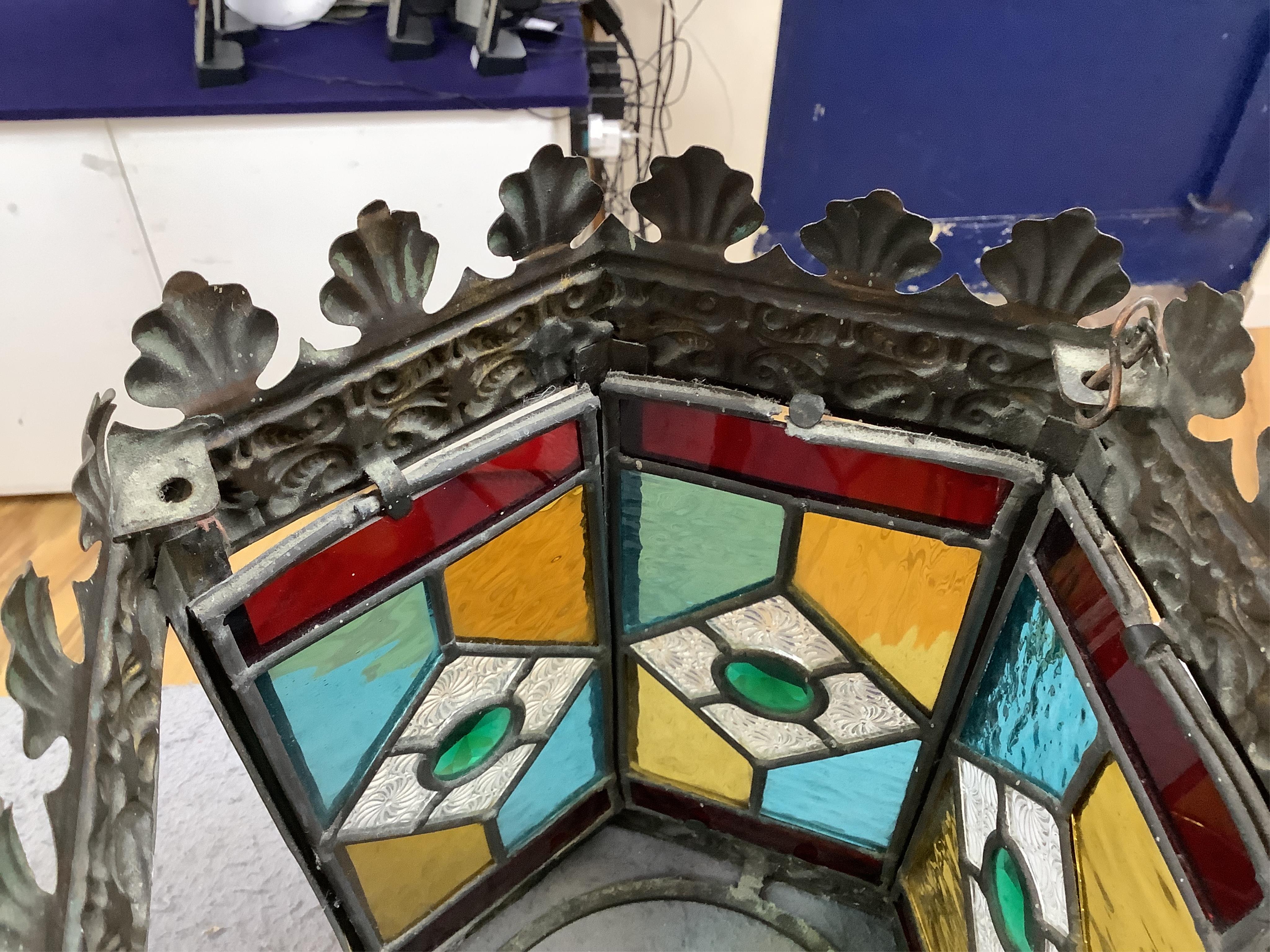 A Victorian coloured stained glass and brass six sided lantern, 31cm high x width 22cm. Condition - glass good, one clip on frame for glass missing